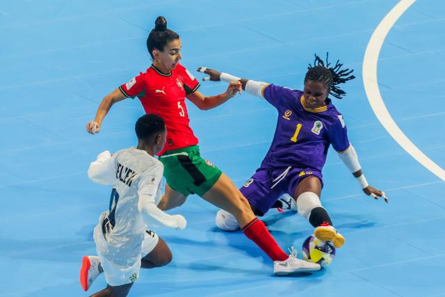 (251123) -- PASIG CITY, Nov. 23, 2025 (Xinhua) -- Debora Lavrador (C) of Portugal competes against Helena Mtundagi (L) and Zuhura Waziri of Tanzania during the Group C match between Portugal and Tanzania at the FIFA Futsal Women's World Cup 2025 in Pasig City, the Philippines, Nov. 23, 2025. (Xinhua/Rouelle Umali)