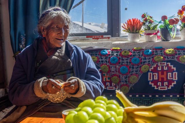 (251123) -- XIGAZE, Nov. 23, 2025 (Xinhua) -- A senior villager sits at her new house in Qaba Village of Dingri County, Xigaze City, southwest China's Xizang Autonomous Region, Nov. 13, 2025. In early January, a 6.8-magnitude earthquake struck Dingri County in the city of Xigaze, leveling thousands of houses. 
   Ten months after the earthquake, more than 32,500 destroyed or damaged houses have been restored and handed over to affected residents, according to the authorities of Xigaze City. 
   In less than three days after the earthquake, Xizang rolled out a post-disaster reconstruction plan and kicked off the preliminary work, which included field survey, housing design and debris clearance.
   The restoration work covered 486 villages in seven counties, resulting in the reconstruction of more than 22,000 houses and the reinforcement of an additional 10,500 homes. The first batch of quake-affected residents have moved into new homes in August. (Xinhua/Jiang Fan)