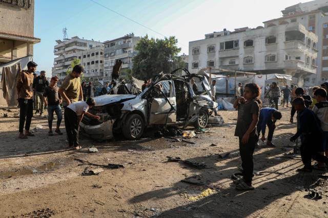 (251123) -- GAZA, Nov. 23, 2025 (Xinhua) -- Palestinians gather around a destroyed vehicle in west of Gaza City, on Nov. 22, 2025. Gaza's Civil Defense said on Saturday that Israel launched a series of airstrikes on the Gaza Strip, resulting in at least 22 deaths and dozens of injuries in the enclave.
   A Hamas source, speaking on condition of anonymity, told Xinhua that the movement has informed regional mediators of its "anger" over continued Israeli attacks on the Gaza Strip, despite Hamas and other Palestinian factions adhering to the ceasefire agreement. (Photo by Rizek Abdeljawad/Xinhua)