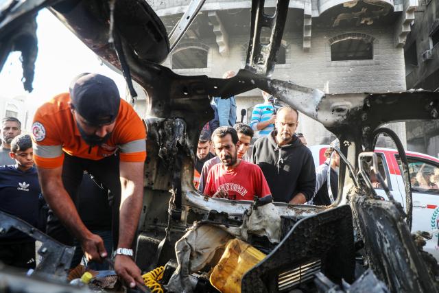 (251123) -- GAZA, Nov. 23, 2025 (Xinhua) -- Palestinians gather around a destroyed vehicle in west of Gaza City, on Nov. 22, 2025. Gaza's Civil Defense said on Saturday that Israel launched a series of airstrikes on the Gaza Strip, resulting in at least 22 deaths and dozens of injuries in the enclave.
   A Hamas source, speaking on condition of anonymity, told Xinhua that the movement has informed regional mediators of its "anger" over continued Israeli attacks on the Gaza Strip, despite Hamas and other Palestinian factions adhering to the ceasefire agreement. (Photo by Rizek Abdeljawad/Xinhua)