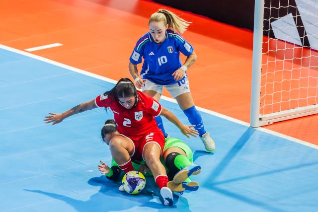 (251123) -- PASIG CITY, Nov. 23, 2025 (Xinhua) -- Goalkeeper Mariam Sanjur (bottom) and Maryorie Perez (front) of Panama compete against Gaby Vanelli of Italy during the group D match between Italy and Panama at the FIFA Futsal Women's World Cup 2025 in Pasig City, the Philippines, Nov. 23, 2025. (Xinhua/Rouelle Umali)