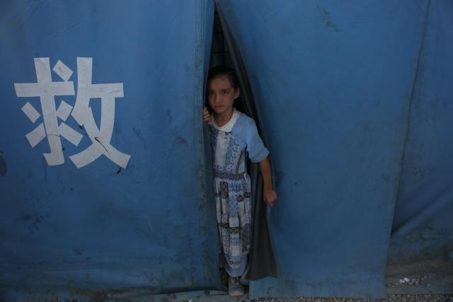 (251123) -- KABUL, Nov. 23, 2025 (Xinhua) -- A child is seen from a tent provided by China in Kabul, Afghanistan, Nov. 23, 2025. A total of 2,102 Afghan families with 11,855 members returned to their homeland from neighboring Iran and Pakistan on Saturday, Afghanistan's High Commission for Addressing Returnees Problems said Sunday.
   The commission provides temporary shelters, nourishment, water, medical care, and transportation services for the returnees. (Photo by Saifurahman Safi/Xinhua)