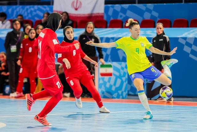 (251123) -- PASIG CITY, Nov. 23, 2025 (Xinhua) -- Emilly (1st R) of Brazil competes during the group D match between Brazil and Iran at the FIFA Futsal Women's World Cup 2025 in Pasig City, the Philippines, Nov. 23, 2025. (Xinhua/Rouelle Umali)