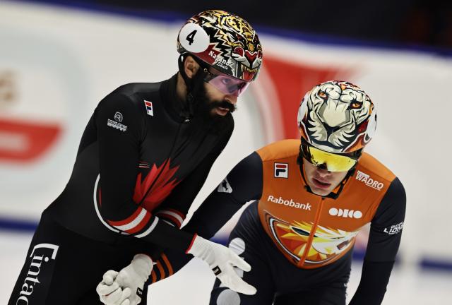 (251124) -- GDANSK, Nov. 24, 2025 (Xinhua) -- Jens van't Wout of the Netherlands (R) celebrates with Steven Dubois of Canada after the men's 1000m final A at the ISU Short Track World Tour #3 speed skating event in Gdansk, Poland, Nov. 23, 2025. (Xinhua/Gao Jing)