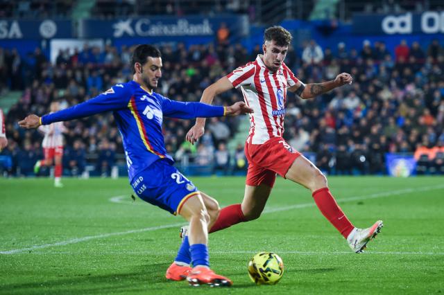 (251124) -- GETAFE, Nov. 24, 2025 (Xinhua) -- Juan Iglesias (L) of Getafe vies with Matteo Ruggeri of Atletico de Madrid during La Liga football match between Getafe CF and Atletico de Madrid in Getafe, Madrid, Spain, on Nov. 23, 2025. (Photo by Gustavo Valiente/Xinhua)