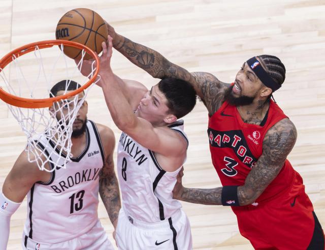 (251124) -- TORONTO, Nov. 24, 2025 (Xinhua) -- Brandon Ingram (R) of Toronto Raptors fights for a rebound with Egor Demin (C) of Brooklyn Nets during the 2025-2026 NBA regular season game between Toronto Raptors and Brooklyn Nets in Toronto, Canada, on Nov. 23, 2025. (Photo by Zou Zheng/Xinhua)