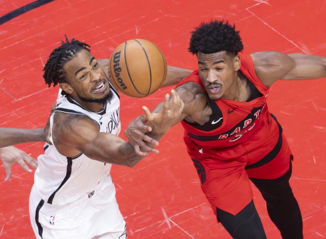 (251124) -- TORONTO, Nov. 24, 2025 (Xinhua) -- Ochai Agbaji (R) of Toronto Raptors vies with Nic Claxton of Brooklyn Nets during the 2025-2026 NBA regular season game between Toronto Raptors and Brooklyn Nets in Toronto, Canada, on Nov. 23, 2025. (Photo by Zou Zheng/Xinhua)