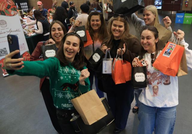 (251124) -- SAN FRANCISCO, Nov. 24, 2025 (Xinhua) -- Shoppers take a selfie during the Chocolate Salon and Festival at Golden Gate Park in San Francisco, the United States, Nov. 23, 2025. (Photo by Liu Yilin/Xinhua)