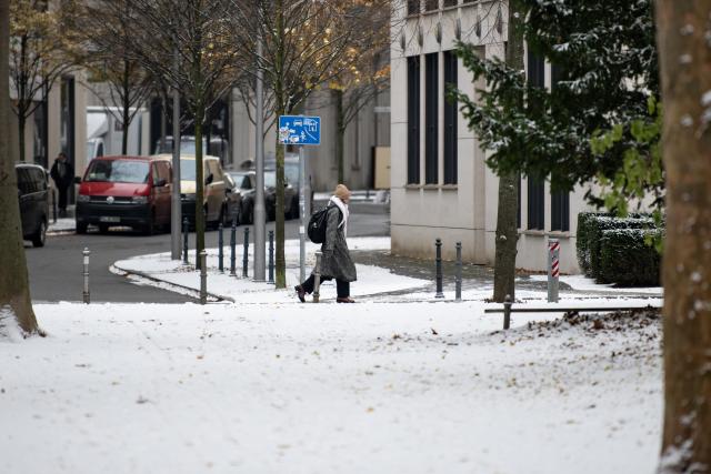 (251124) -- BERLIN, Nov. 24, 2025 (Xinhua) -- A woman walks on a street in Berlin, Germany, Nov. 24, 2025. Berlin saw its first snowfall of the winter season on Monday. (Xinhua/Zhang Haofu)