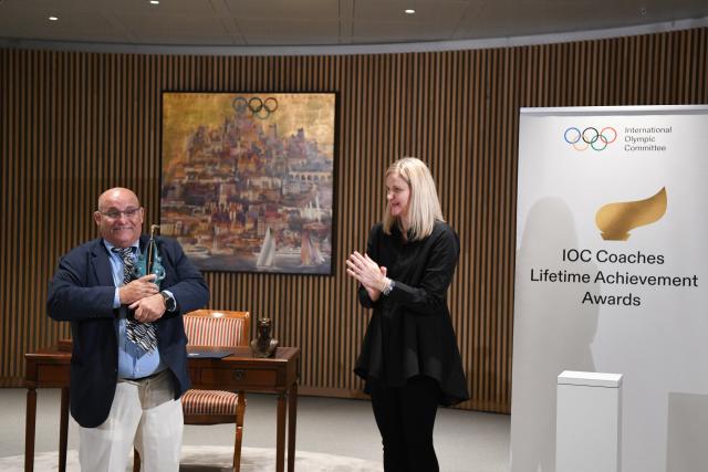 (251125) -- LAUSANNE, Nov. 25, 2025 (Xinhua) -- IOC President Kirsty Coventry (R) applauds after handing the trophy of IOC Coaches Lifetime Achievement Award to Cuba's wrestling coach Raul de Jesus Trujillo Diaz at the Olympic House in Lausanne, Switzerland, Nov. 24, 2025. The International Olympic Committee (IOC) on Monday honored Chinese volleyball coach Lang Ping and Cuban wrestling coach Raul de Jesus Trujillo Diaz with the IOC Coaches Lifetime Achievement Awards. (Xinhua/Lian Yi)