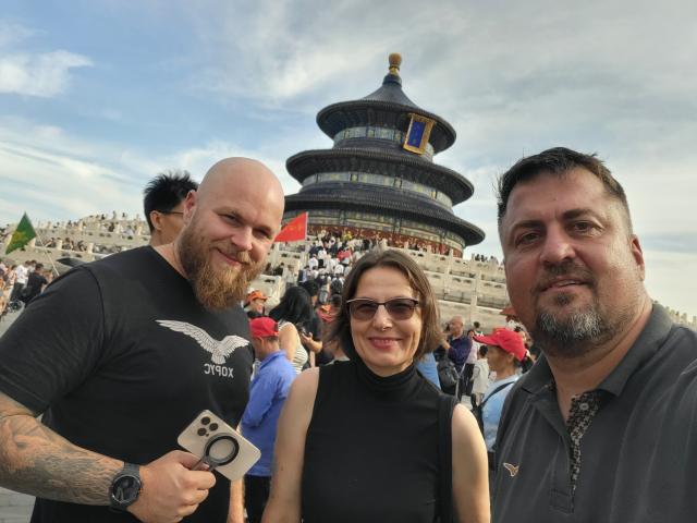 (251125) -- BELGRADE, Nov. 25, 2025 (Xinhua) -- This undated photo shows Serbian documentary producer Bosko Kozarski (R) posing for a photo with Tatjana Soldat (C), director of the Serbian Cultural Center in Beijing, at Tiantan (Temple of Heaven) Park in Beijing, capital of China. TO GO WITH "Feature: Serbian documentary producer finds inspiration in Beijing's blend of history, modern life" (Xinhua)
