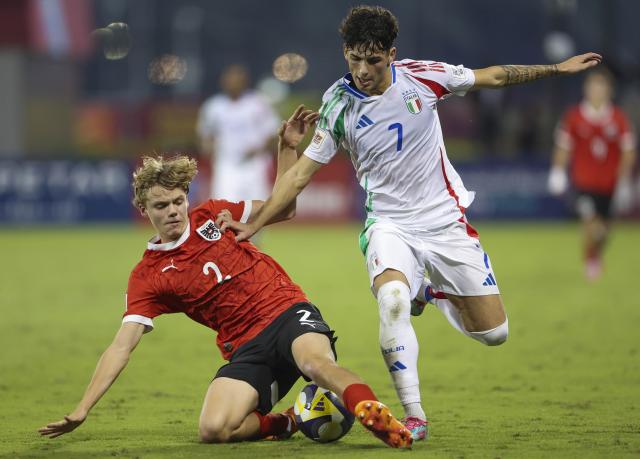(251125) -- DOHA, Nov. 25, 2025 (Xinhua) -- Rafael Feldinger (L) of Austria vies with Andrea Luongo of Italy during the semifinal match between Austria and Italy at the FIFA U17 World Cup 2025 in Doha, Qatar, on Nov. 24, 2025. (Photo by Nikku/Xinhua)