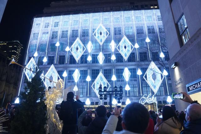 (251125) -- NEW YORK, Nov. 25, 2025 (Xinhua) -- People watch a light show in New York, the United States, Nov. 24, 2025. The Saks Fifth Avenue Holiday Light Show 2025 kicked off in New York City on Monday. (Xinhua/Zhang Fengguo)
