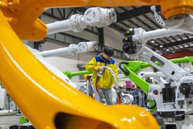 (251125) -- WUHU, Nov. 25, 2025 (Xinhua) -- A worker assembles an industrial robot at Efort Intelligent Robot Co., Ltd. in Wuhu, east China's Anhui Province, Nov. 20, 2025. Wuhu in east China's Anhui Province is a key manufacturing hub, with its manufacturing sector covering 37 out of the country's 41 major industrial categories. Its signature industries include automobiles, green energy, and smart household appliances, each of which generates an annual output value reaching 100 billion yuan (about 14 billion U.S. dollars).
  The city has also seen a rapid rise in the robot industry in recent years thanks to the development of AI technologies and the city's solid industrial foundation. A state-level robot industry cluster is taking shape here, with more than 300 enterprises contributing to a comprehensive industrial chain worth 40 billion yuan (about 563 million U.S. dollars) in 2024. (Photo by Xiao Benxiang/Xinhua)