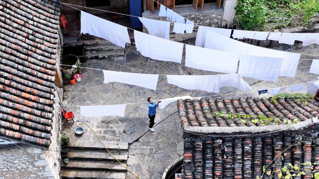 (251125) -- GUIYANG, Nov. 25, 2025 (Xinhua) -- An aerial drone photo shows a homestay at Pingjie Town of Bouyei-Miao Autonomous Prefecture of Qianxinan, southwest China's Guizhou Province, Nov. 6, 2025. The Huajiang Grand Canyon Bridge, soaring 625 meters above the Beipan River in Guizhou's mountainous terrain, is the world's highest bridge. The mega-project is also helping boost tourism in the nearby Pingjie Town, which has benefited from the improved traffic condition. (Xinhua/Ou Dongqu)