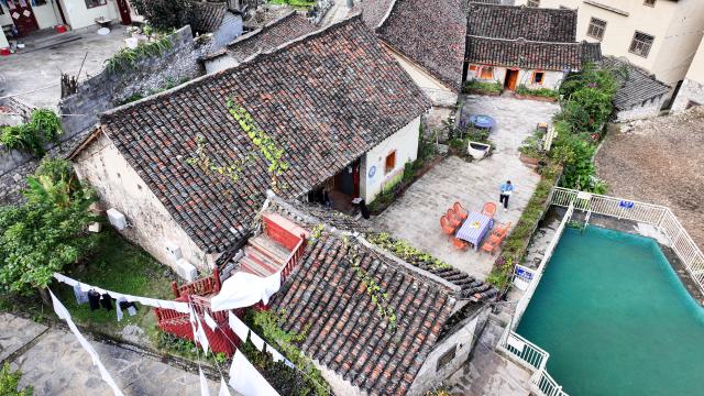 (251125) -- GUIYANG, Nov. 25, 2025 (Xinhua) -- An aerial drone photo shows a homestay at Pingjie Town of Bouyei-Miao Autonomous Prefecture of Qianxinan, southwest China's Guizhou Province, Nov. 6, 2025. The Huajiang Grand Canyon Bridge, soaring 625 meters above the Beipan River in Guizhou's mountainous terrain, is the world's highest bridge. The mega-project is also helping boost tourism in the nearby Pingjie Town, which has benefited from the improved traffic condition. (Xinhua/Ou Dongqu)