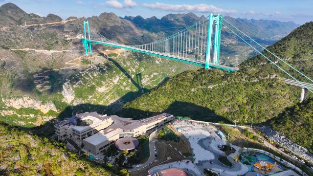 (251125) -- GUIYANG, Nov. 25, 2025 (Xinhua) -- This aerial drone photo taken on Nov. 6, 2025 shows the Huajiang Grand Canyon Bridge and the nearby Yundu service area in southwest China's Guizhou Province. The Huajiang Grand Canyon Bridge, soaring 625 meters above the Beipan River in Guizhou's mountainous terrain, is the world's highest bridge. The nearby Yundu service area features a comprehensive complex that integrates bridge viewing, sports experiences and other tourism services. (Xinhua/Ou Dongqu)