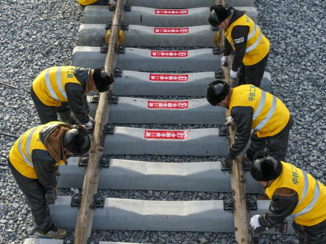 (251125) -- QING'AN, Nov. 25, 2025 (Xinhua) -- An drone photo taken on Nov. 25, 2025 shows constructors working at a construction site of the Harbin-Yichun high-speed railway in Qing'an County, northeast China's Heilongjiang Province. Track-laying for the Harbin-Yichun high-speed railway completed on Tuesday. The Harbin-Yichun high-speed railway is China's northernmost high-speed railway under construction. (Xinhua/Wang Song)
