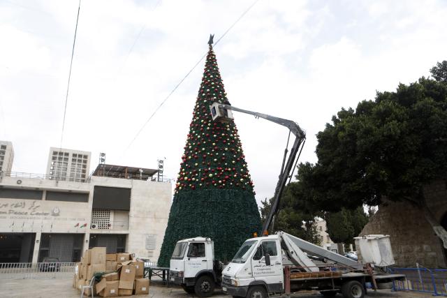 (251125) -- BETHLEHEM, Nov. 25, 2025 (Xinhua) -- Photo taken on Nov. 25, 2025, shows the installation of a Christmas tree in the Manger Square in the West Bank city of Bethlehem before the Christmas season. The decorations and lighting are expected to be completed in the coming days, ahead of announcing this year's Christmas program. (Photo by Mamoun Wazwaz/Xinhua)