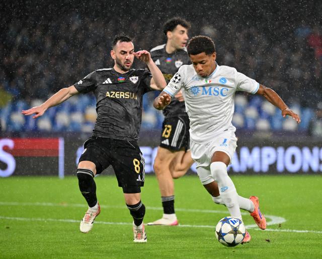 (251126) -- NAPLES, Nov. 26, 2025 (Xinhua) -- Napoli's David Neres (R) vies with Qarabag's Marko Jankovic during the UEFA Champions League match between Napoli and Qarabag in Naples, Italy, Nov. 25, 2025. (Photo by Alberto Lingria/Xinhua)