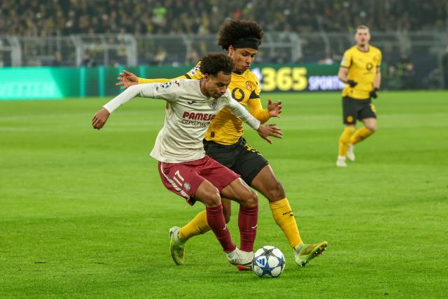 (251126) -- DORTMUND, Nov. 26, 2025 (Xinhua) -- Karim Adeyemi (R) of Borussia Dortmund vies with Tajon Buchanan of Villarreal CF during the UEFA Champions League group stage 5th round match between Borussia Dortmund and Villarreal CF in Dortmund, Germany, Nov. 25, 2025. (Photo by Joachim Bywaletz/Xinhua)
