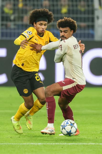 (251126) -- DORTMUND, Nov. 26, 2025 (Xinhua) -- Karim Adeyemi (L) of Borussia Dortmund vies with Renato Veiga of Villarreal CF during the UEFA Champions League group stage 5th round match between Borussia Dortmund and Villarreal CF in Dortmund, Germany, Nov. 25, 2025. (Photo by Joachim Bywaletz/Xinhua)