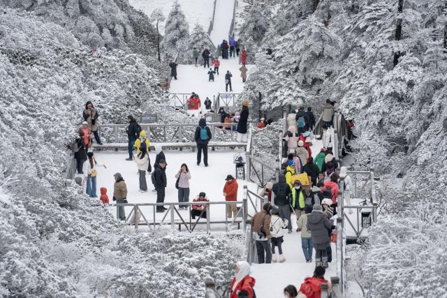 (251126) -- BEIJING, Nov. 26, 2025 (Xinhua) -- Visitors enjoy ice and snow scenery on Cangshan Mountain in Dali, southwest China's Yunnan Province, Nov. 24, 2025. Cangshan Mountain greeted the first snowfall of this winter. (Photo by Luo Zhu/Xinhua)