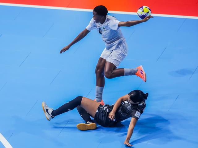 (251126) -- PASIG CITY, Nov. 26, 2025 (Xinhua) -- Winfrida Charles (back) of Tanzania competes against Shivy Anthony of New Zealand during the group C match between New Zealand and Tanzania at the FIFA Futsal Women's World Cup 2025 in Pasig City, the Philippines, Nov. 26, 2025. (Xinhua/Rouelle Umali)