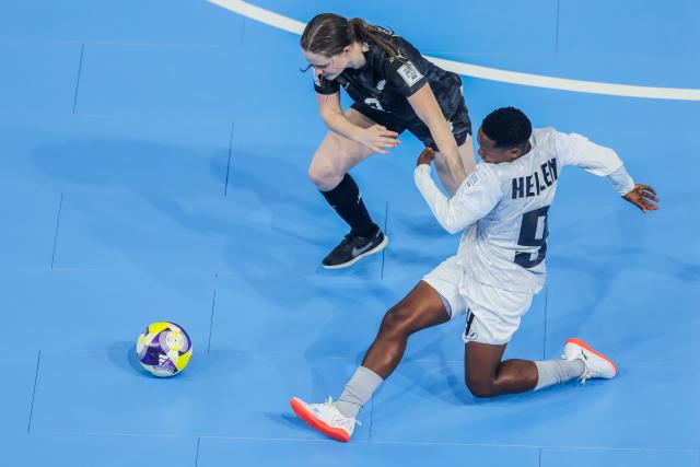 (251126) -- PASIG CITY, Nov. 26, 2025 (Xinhua) -- Helena Mtundagi (R) of Tanzania competes against Jordana Bremner of New Zealand during the group C match between New Zealand and Tanzania at the FIFA Futsal Women's World Cup 2025 in Pasig City, the Philippines, Nov. 26, 2025. (Xinhua/Rouelle Umali)