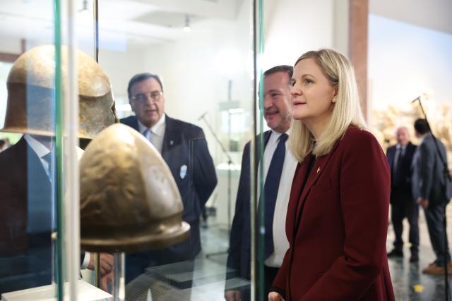 (251126) -- ANCIENT OLYMPIA, Nov. 26, 2025 (Xinhua) -- International Olympic Committee (IOC) President Kirsty Coventry (R) observes an artifact at the Archaeological Museum of Olympia as she arrives before the Olympic flame lighting ceremony for the Milan-Cortina 2026 Winter Olympic Games in Ancient Olympia, Greece, on Nov. 26, 2025. (Xinhua/Li Jing)
