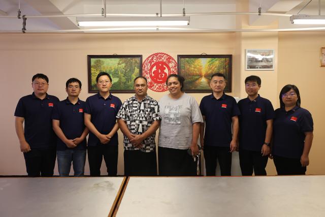 (251126) -- NUKU'ALOFA, Nov. 26, 2025 (Xinhua) -- Aisea Latu Talia'uli (4th L) and his wife (4th R) pose for photos with members of the sixth batch of the Chinese medical team to Tonga, in Nuku'alofa, Tonga on Nov. 8, 2025. TO GO WITH "Feature: Chinese medical aid brings new lease of life to Tongan patient" (The sixth batch of the Chinese medical team to Tonga /Handout via Xinhua)