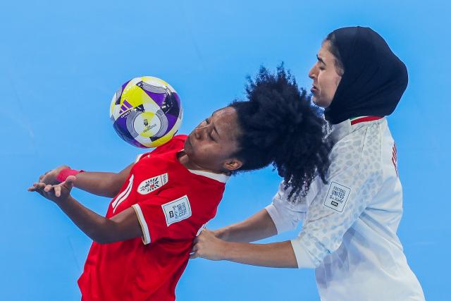 (251126) -- PASIG CITY, Nov. 26, 2025 (Xinhua) -- Erika Hernandez (L) of Panama competes against Fatemeh Rahmati of Iran during the group D match between Iran and Panama at the FIFA Futsal Women's World Cup 2025 in Pasig City, the Philippines, on Nov. 26, 2025. (Xinhua/Rouelle Umali)