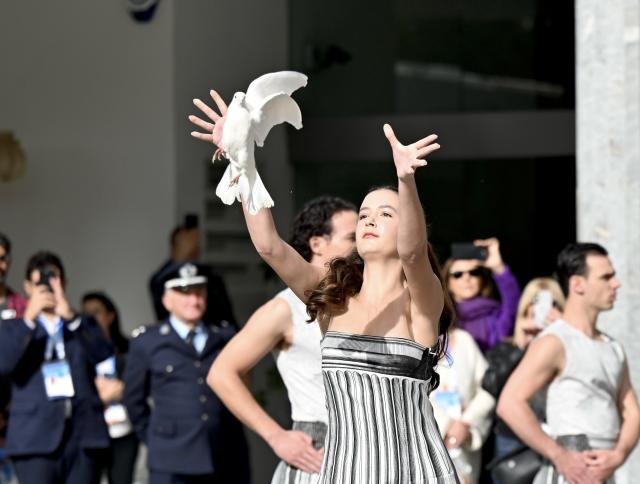 (251126) -- ANCIENT OLYMPIA, Nov. 26, 2025 (Xinhua) -- A performer releases a dove during the Olympic flame lighting ceremony for the Milan-Cortina 2026 Winter Olympic Games in Ancient Olympia, Greece, on Nov. 26, 2025. (Xinhua/Lyu You)