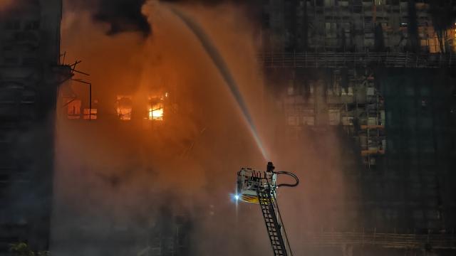 (251126) -- HONG KONG, Nov. 26, 2025 (Xinhua) -- This photo taken on Nov. 26, 2025 shows rescuers working on a residential building fire site in Hong Kong, south China. Thirteen people were killed after a huge fire engulfed a residential area in the Tai Po area of Hong Kong on Wednesday afternoon, according to a press release issued by the Hong Kong Special Administrative Region (HKSAR) government. (Xinhua/Chen Duo)