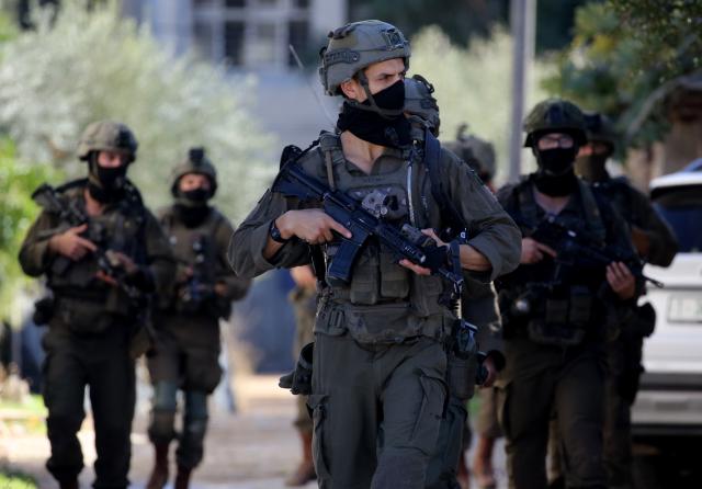 (251126) -- TUBAS, Nov. 26, 2025 (Xinhua) -- Israeli soldiers patrol a street during a large-scale military operation in the West Bank city of Tubas, Nov. 26, 2025. Israel launched a large-scale military operation in the northern West Bank on Wednesday, imposing a curfew, setting up roadblocks, and deploying military forces, according to Israeli and Palestinian sources. (Photo by Nidal Eshtayeh/Xinhua)