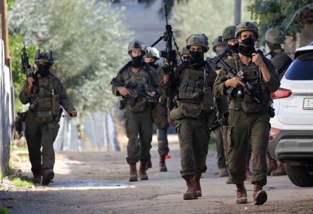 (251126) -- TUBAS, Nov. 26, 2025 (Xinhua) -- Israeli soldiers patrol a street during a large-scale military operation in the West Bank city of Tubas, Nov. 26, 2025. Israel launched a large-scale military operation in the northern West Bank on Wednesday, imposing a curfew, setting up roadblocks, and deploying military forces, according to Israeli and Palestinian sources. (Photo by Nidal Eshtayeh/Xinhua)