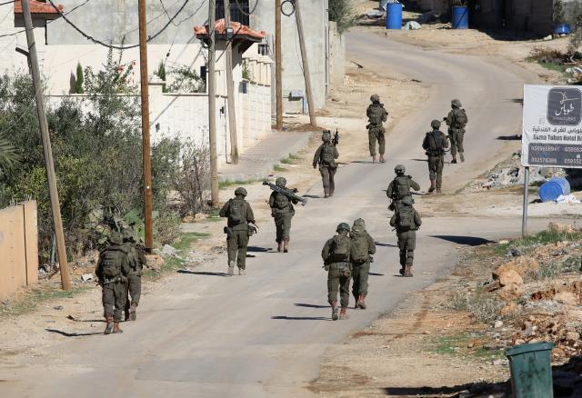 (251126) -- TUBAS, Nov. 26, 2025 (Xinhua) -- Israeli soldiers patrol a street during a large-scale military operation in the West Bank city of Tubas, Nov. 26, 2025. Israel launched a large-scale military operation in the northern West Bank on Wednesday, imposing a curfew, setting up roadblocks, and deploying military forces, according to Israeli and Palestinian sources. (Photo by Nidal Eshtayeh/Xinhua)