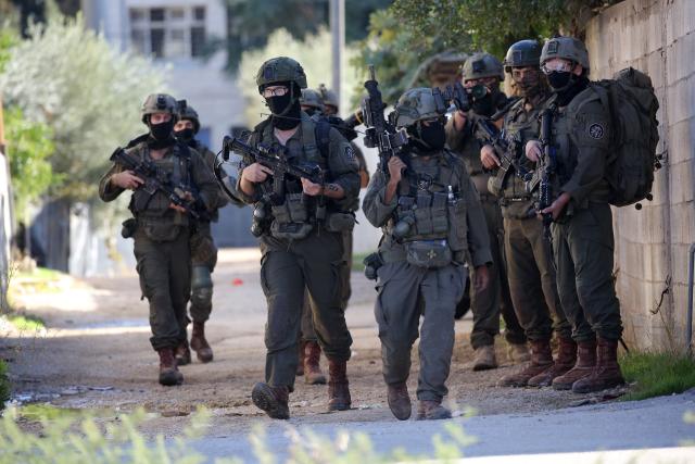 (251126) -- TUBAS, Nov. 26, 2025 (Xinhua) -- Israeli soldiers patrol a street during a large-scale military operation in the West Bank city of Tubas, Nov. 26, 2025. Israel launched a large-scale military operation in the northern West Bank on Wednesday, imposing a curfew, setting up roadblocks, and deploying military forces, according to Israeli and Palestinian sources. (Photo by Nidal Eshtayeh/Xinhua)