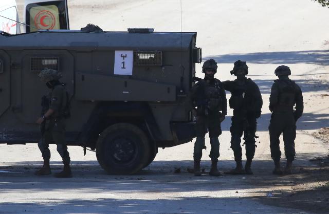 (251126) -- TUBAS, Nov. 26, 2025 (Xinhua) -- Israeli soldiers guard a roadblock during a large-scale military operation in the West Bank city of Tubas, Nov. 26, 2025. Israel launched a large-scale military operation in the northern West Bank on Wednesday, imposing a curfew, setting up roadblocks, and deploying military forces, according to Israeli and Palestinian sources. (Photo by Nidal Eshtayeh/Xinhua)