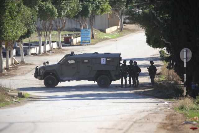 (251126) -- TUBAS, Nov. 26, 2025 (Xinhua) -- Israeli soldiers guard a roadblock during a large-scale military operation in the West Bank city of Tubas, Nov. 26, 2025. Israel launched a large-scale military operation in the northern West Bank on Wednesday, imposing a curfew, setting up roadblocks, and deploying military forces, according to Israeli and Palestinian sources. (Photo by Nidal Eshtayeh/Xinhua)