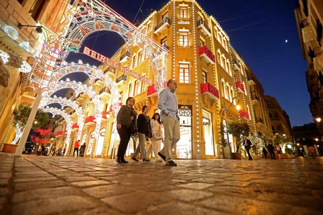 (251126) -- BEIRUT, Nov. 26, 2025 (Xinhua) -- People walk through a street adorned with Christmas decorations in Beirut, Lebanon, Nov. 26, 2025. (Photo by Bilal Jawich/Xinhua)