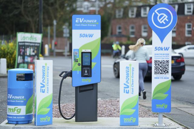 (251127) -- MANCHESTER, Nov. 27, 2025 (Xinhua) -- A woman runs past a charging station in Manchester, Britain, Nov. 26, 2025. British Chancellor of the Exchequer Rachel Reeves unveiled the 2025 Budget on Wednesday, pledging that the government will neither return the country to austerity nor allow public spending and borrowing to spiral, while vowing to ease pressures on the cost of living.
  According to a statement published on the British government's website, Reeves set out a wide range of proposals on public spending and taxation aimed at reducing borrowing and debt, safeguarding essential public services, stimulating economic growth, improving tax fairness, and advancing welfare reforms. (Photo by Jon Super/Xinhua)