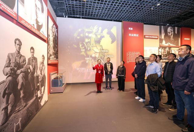 (251127) -- BEIJING, Nov. 27, 2025 (Xinhua) -- A staff member introduces exhibits to visitors at the exhibition titled "For a Common Cause: From the Spanish Battlefield to China's War of Resistance Against Japanese Aggression" held at the Museum of the Communist Party of China (CPC) in Beijing, capital of China, Nov. 14, 2025. (Xinhua/Yin Gang)