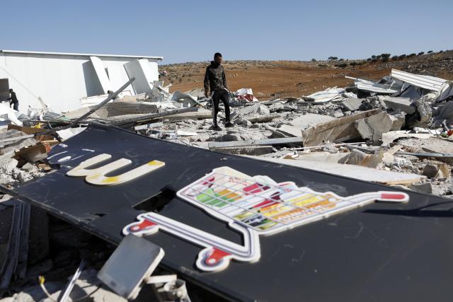 (251127) -- HEBRON, Nov. 27, 2025 (Xinhua) -- A man checks the rubble of commercial shops demolished by Israeli military bulldozers in south of the West Bank city of Hebron, Nov. 26, 2025. (Photo by Mamoun Wazwaz/Xinhua)
