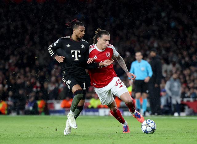 (251127) -- LONDON, Nov. 27, 2025 (Xinhua) -- Arsenal's Riccardo Calafiori (R) vies with Bayern Munich's Michael Olise during the UEFA Champions League football match between Arsenal and Bayern Munich in London, Britain, Nov. 26, 2025. (Xinhua/Li Ying)