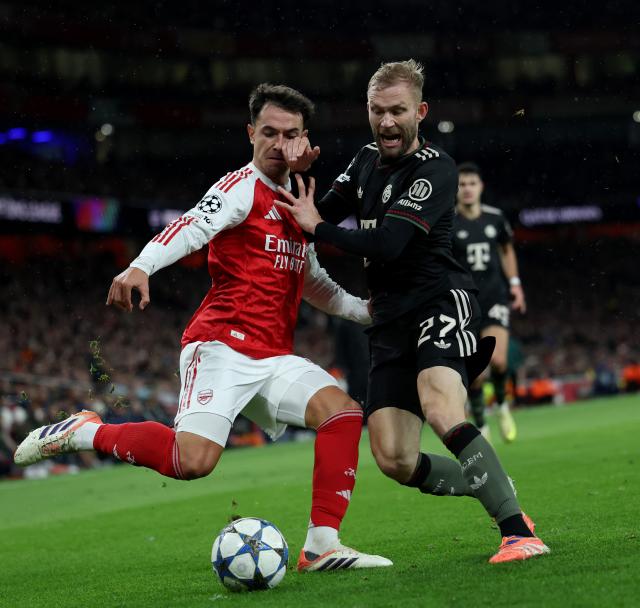 (251127) -- LONDON, Nov. 27, 2025 (Xinhua) -- Arsenal's Martin Zubimendi (L) vies with Bayern Munich's Konrad Laimer during the UEFA Champions League football match between Arsenal and Bayern Munich in London, Britain, Nov. 26, 2025. (Xinhua/Li Ying)