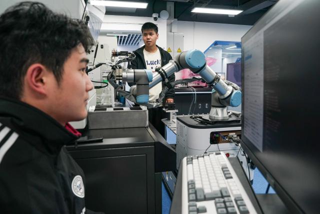 (251127) -- HEFEI, Nov. 27, 2025 (Xinhua) -- Researchers adjust robots at the state key laboratory of precision and intelligent chemistry of the University of Science and Technology of China (USTC) in Hefei, east China's Anhui Province, Nov. 24, 2025. Traditional chemical research has long relied on continuous trial and error by scientists. With the development of artificial intelligence and robotic automation technologies, it has become possible to design experiments and issue instructions through intelligent platforms, using robots to replace human labor in experiential operations, which enhances experimental efficiency and precision. 
   In 2021, after eight years of dedicated effort by a research team from USTC, Xiaolai, the first-generation "robot chemist," was successfully developed. After several years of iterations, the second-generation dual-armed humanoid robot Xiaolin has been put into operation, capable of performing more complex tasks. It has evolved from a substitute of human labor to a "research partner."
   According to Zhu Zhuoying, a professor from the state key laboratory of precision and intelligent chemistry at USTC, the team's ultimate goal is to enable robots to achieve fully autonomous scientific research. In the future, they might identify entirely new research directions by "reading" literature themselves and achieve breakthroughs in areas beyond human exploration. (Xinhua/Du Yu)