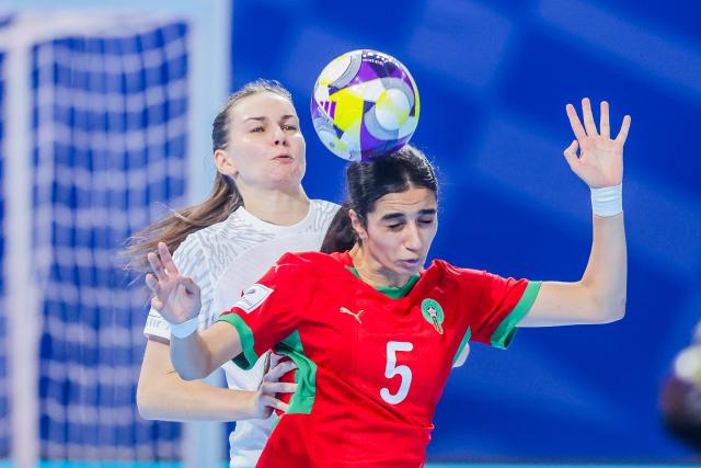 (251127) -- PASIG CITY, Nov. 27, 2025 (Xinhua) -- Jasmine Demraoui (front) of Morocco competes against Wiktoria Pietrzyk (Back) of Poland during the group A match between Morocco and Poland at the FIFA Futsal Women's World Cup 2025 in Pasig City, the Philippines, Nov. 27, 2025. (Xinhua/Rouelle Umali)