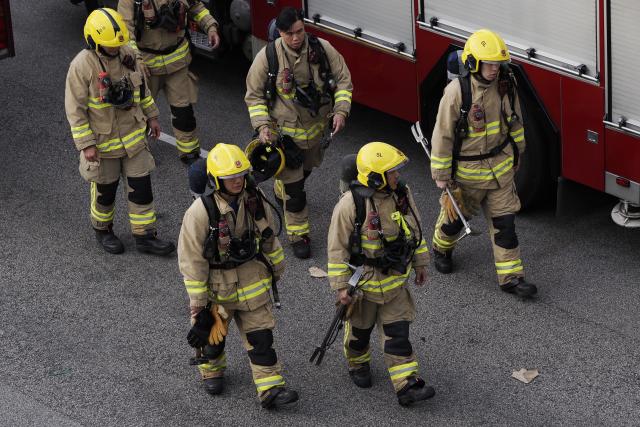 (251127) -- HONG KONG, Nov. 27, 2025 (Xinhua) -- Firefighters head towards the rescue site in Wang Fuk Court, a residential area in Tai Po of Hong Kong, south China, Nov. 27, 2025. Firefighters had rescued 55 people in the major fire in the residential complex Wang Fuk Court in Hong Kong, John Lee, chief executive of the Hong Kong Special Administrative Region, said at a press briefing on Thursday. (Xinhua/Wang Shen)