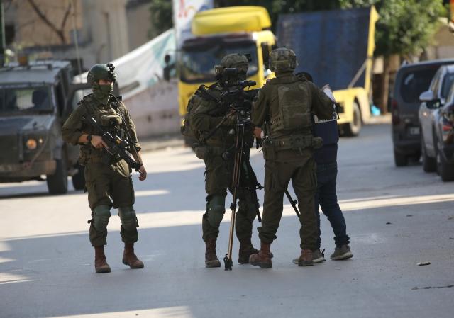 (251127) -- TUBAS, Nov. 27, 2025 (Xinhua) -- Israeli soldiers prevent Palestinian journalists from reporting during an Israeli military operation in the West Bank city of Tubas, on Nov. 27, 2025. At least 25 Palestinians were injured and 119 others detained in the northern West Bank city of Tubas as an Israeli military operation entered its second day, Palestinian officials said on Thursday. (Photo by Nidal Eshtayeh/Xinhua)